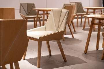 Modern chairs in empty cafe with natural light