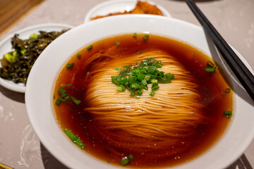 Bowl of noodle soup with fresh toppings