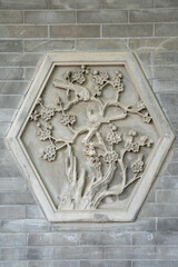 Carved stone relief with birds and blossoms