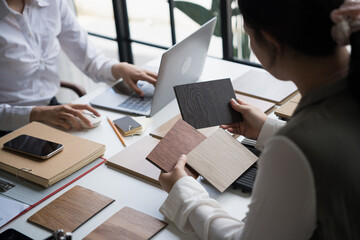 Interior designer presenting eco friendly wooden material samples for sustainable home decor