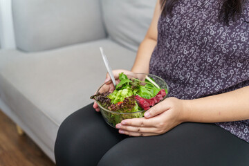 Asian Overweight woman dieting Weight loss eating fresh fresh homemade salad healthy eating concept...