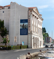 A bright daytime view of the Sergej Mazhera Maritime Museum (Pomorski muzej Sergej Mazhera) in Piran, Slovenia, an important cultural landmark on the waterfront
