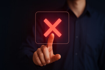 Businessman Touching Glowing Red X Delete Icon on Virtual Screen in Dark Background for Technology and User Interface Concept