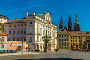 A view of gothic buildings surrounding the square leading to the entrance to the castle complex in...
