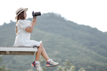 Straw hat girl with a view of Koh Samet Nang Chee, a tourist attraction in Phang Nga Province