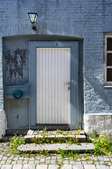 Rustic Blue Brick Wall Featuring White Door With Stone Steps, Trondheim, Norway