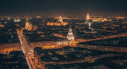 Fototapeta premium Night cityscape with illuminated buildings and street lights creating a vibrant urban panorama view