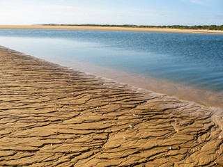Flow off marks on the sandy beach, at low tide, of a small sheltered Bay in the Inahaca Barrier...