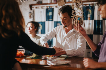 Friends gathering together in a warmly lit bar, sharing moments and conversations at the counter.