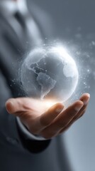 A businessman holds a glowing digital Earth globe representing global business technology and future network innovation