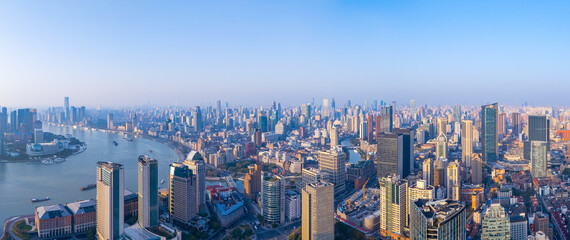 Aerial view of Shanghai skyline with winding river at sunrise.