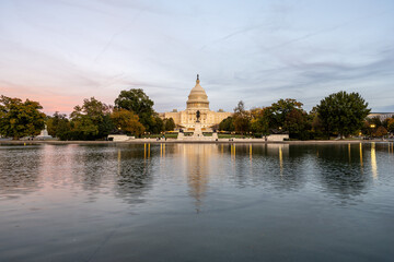 The United States Capitol in Washington DC with the famous reflection pool after sunset