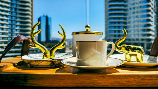 Turkish coffee served with golden decor on a wooden tray