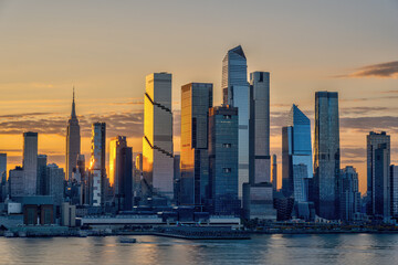 he skyline of Midtown Manhattan in New York with the famous Empire State Building with the first rays of sunshine of the day