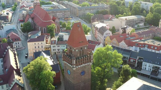 Aerial view of Schlossturm (Cottbus), Germany, surrounded by pastel buildings and lush green trees