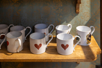 London, UK, 12 May 2025, Liberty shop. Collection of white ceramic mugs with heart designs.