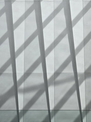 Modern architectural wall with shadows creating dynamic patterns