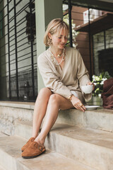 stylish girl, blonde holding cup of coffee, warming drink, good start of day, coffee aroma