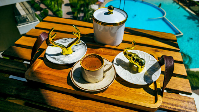 Turkish coffee served with golden decor on a wooden tray