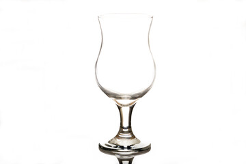 A clear glass goblet stands upright on a white background. The goblet has a curved shape and a...