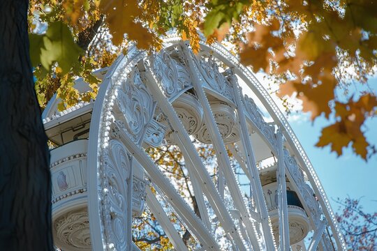 Close-up photo of an amusement park Ferris wheel, white metal frame with ornate carvings