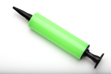 A green balloon pump with a black nozzle on a white background. The pump is cylindrical and designed for inflating balloons quickly and easily.