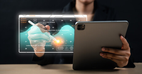 A person interacts with a futuristic digital interface displaying data graphs and charts while...