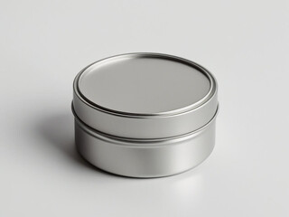 A blank round tin container with closed lid, placed on a white background, minimal product packaging mockup