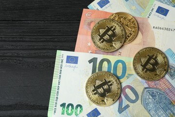 Close up of metal shiny bitcoin crypto currency coins on euro banknotes. Electronic decentralized money concept. 