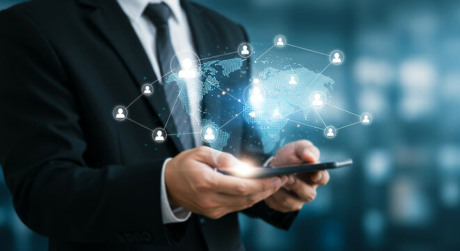 Global Network on Mobile: A businessman in a sleek suit holds a smartphone displaying a glowing world map connected by a complex network of nodes, symbolizing global connection and network expansion.