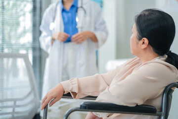 experienced female medical professional explains test results to a female patient during a clinic consultation. reviewing reports and discussing diagnosis and treatment options.compassionate care