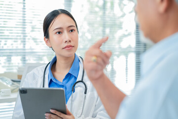 female doctor measures the blood pressure elderly male patient.health consultation, explains medication and prescription details, and offers emotional support. doctor-patient bonding.young profession