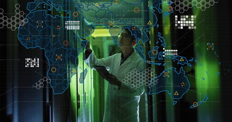 Reaching Korean engineer wearing lab coat holding tablet in green data center corridor, network map