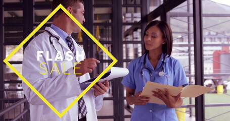 Doctor in lab coat, nurse in scrubs standing in clinic corridor, with stethoscopes, flash sale sign