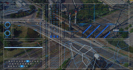 Displaying aerial highway interchange over city, highlighting ramps, vehicles and digital overlay