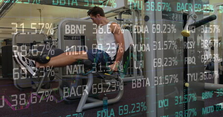Extending legs on leg extension machine at fitness center wearing sportswear and financial overlays