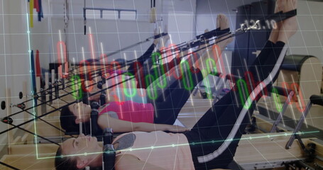 Exercising six women in sportswear using straps on reformers in pilates studio, candlestick overlay