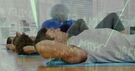 Crunching man in sportswear on blue mat in fitness studio with large stability balls, copy space
