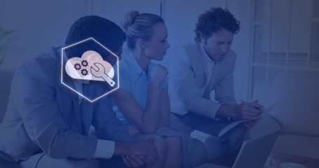 Business professionals reviewing documents on laptop in office lounge, with cloud-gear overlay icon