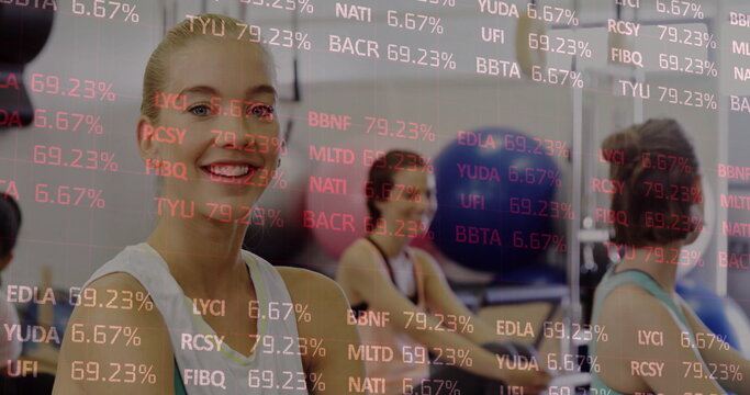 Adult woman wearing white tank top balancing on exercise ball in gym, with floating data overlay