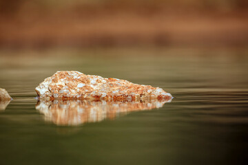 Stone in middle of water to use for background multiple images