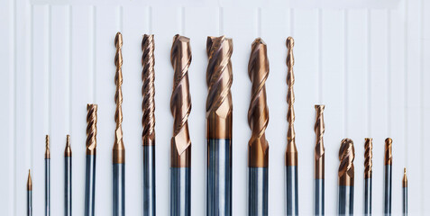 Various cnc drill bits displayed on a white surface for precision machining