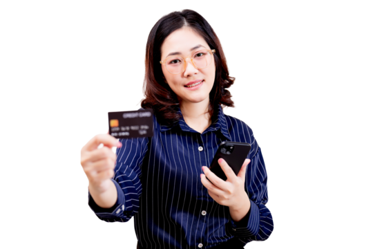 Asian young beautiful woman wearing glasses holds a credit card in one hand and a smartphone in the other, smiling confidently.