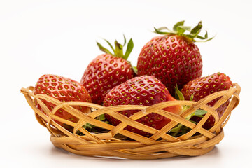 A basket filled with fresh, ripe strawberries. The strawberries are bright red with green leaves, arranged neatly in a woven wicker basket.