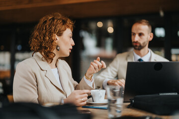 Two professionals engage in a focused conversation in an outdoor setting, emphasizing collaboration...