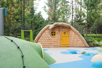 A whimsical playhouse in a sunny park setting, perfect for children's outdoor fun.