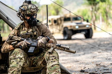 Elite Special Forces Soldier in Tactical Gear Preparing Weapon – Combat Mission Readiness Near...