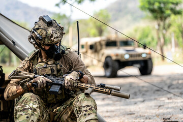 Elite Special Forces Soldier in Tactical Gear Preparing Weapon – Combat Mission Readiness Near...