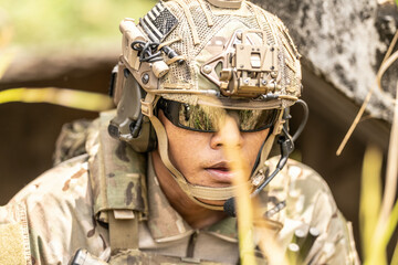 Close-up of special forces soldier climbing rope ladder during urban operation, wearing tactical...