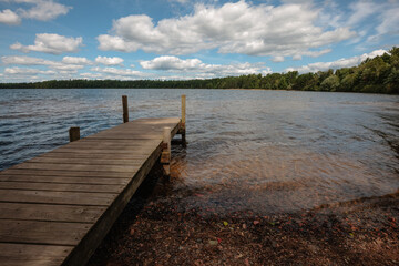 Late August at White Sand Lake, Boulder Junction, Wisconsin, with its wooden pier inviting the...